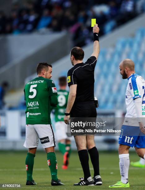 Fredric Fendrich of Jonkopings Sodra IF is shown a yellow card by Jonas Eriksson, referee during the Allsvenskan match between IFK Norrkoping and...