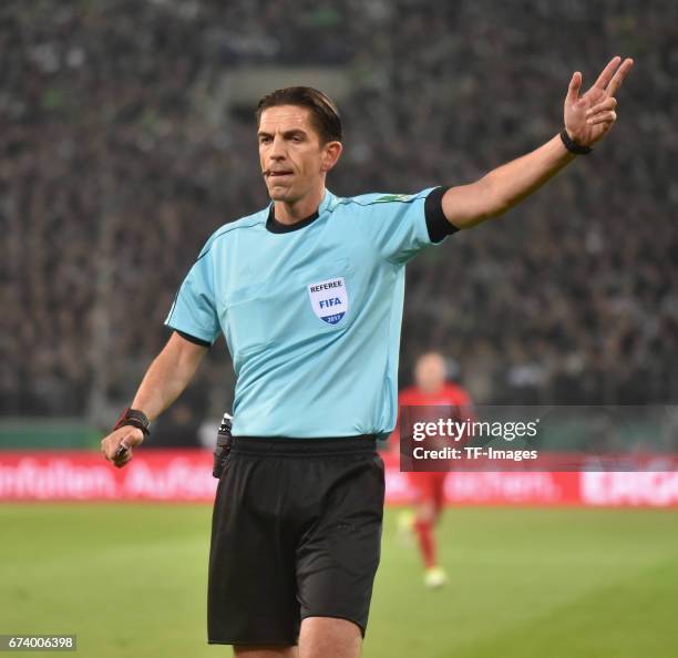 Referee Deniz Aytekin gestures during the DFB Cup semi final match between Borussia Moenchengladbach and Eintracht Frankfurt at Borussia-Park on...