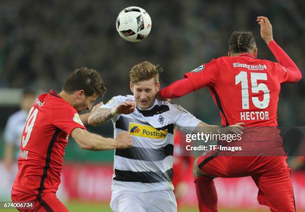 Andre Hahn of Moenchengladbach and David Abraham of Frankfurt and Michael Hector battle for the ball during the DFB Cup semi final match between...