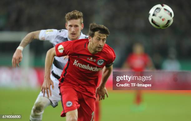 Andre Hahn of Moenchengladbach and David Abraham of Frankfurt battle for the ball during the DFB Cup semi final match between Borussia...