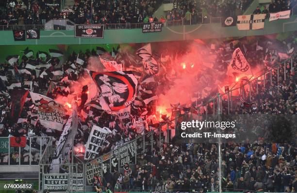 Fans of Frankfurt fire up bengalo / pyro / firework during the DFB Cup semi final match between Borussia Moenchengladbach and Eintracht Frankfurt at...