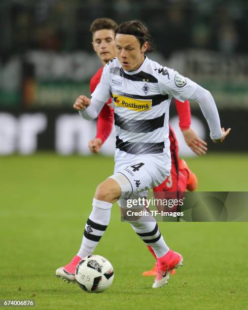 Nico Schulz of Moenchengladbach controls the ball during the DFB Cup semi final match between Borussia Moenchengladbach and Eintracht Frankfurt at...