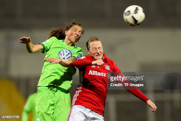 Sara Bjoerk Gunnarsdottir of Wolfsburg and Melanie Behringer of Munich battle for the ball during the Women's DFB Cup Quarter Final match between FC...