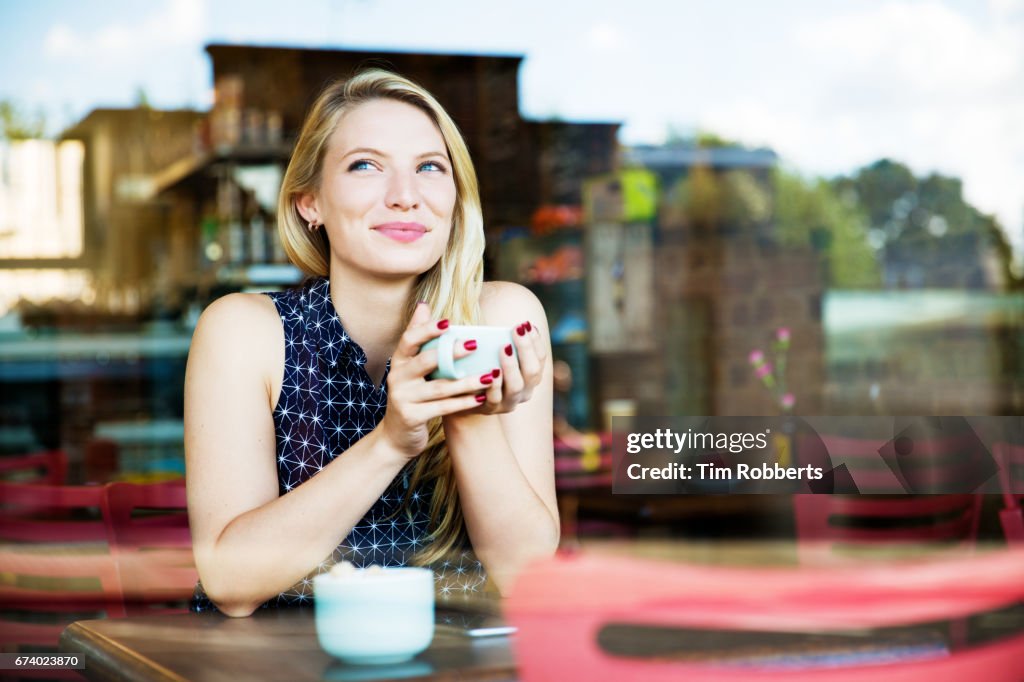 Woman with drink in coffee shop