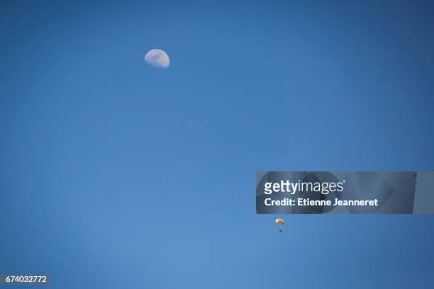 paraglider and moon in blue sky, maroc, 2017 - échappée belle stock pictures, royalty-free photos & images