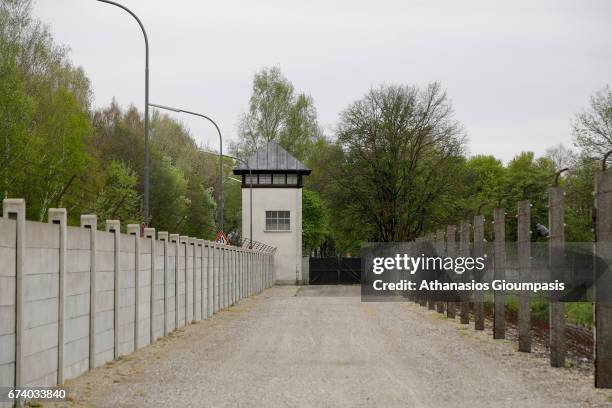 Guard tower with a moat and barbed wire of the Dachau Arbeit concentration camp on April 14, 2017 in Dachau, Germany. Dachau was the first Nazi...