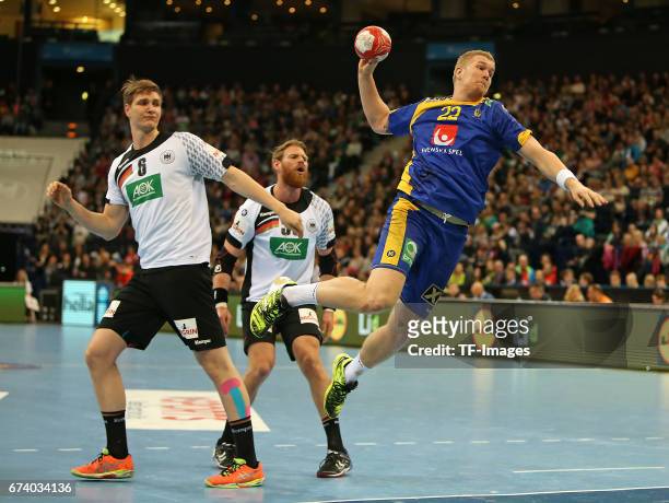 March 19: Finn Lemke of Germany and Manuel Spaeth of Germany and Anton Lindskog of Sweden battle for the ball during the match Germany vs. Sweden at...