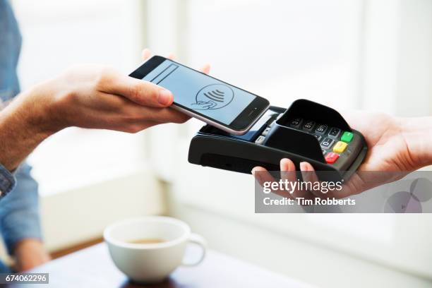 close up of mobile payment - apple pay mobile payment stock-fotos und bilder