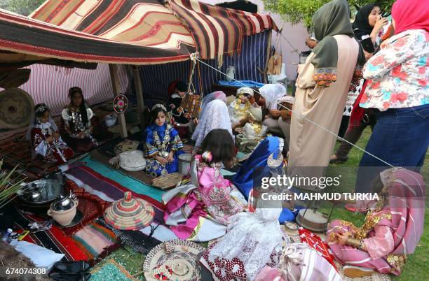 Libyan girls dressed in traditional outfits attend a school event in the Tajoura area in the capital Tripoli on April 2017. / AFP PHOTO / MAHMUD...