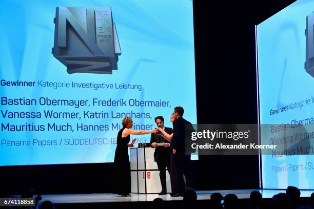 Jury member Giovanni di Lorenzo hands over the 'Investigative Journalism' Award to Vanessa Wormer and Frederik Obermaier for 'Panama Papers' at the...