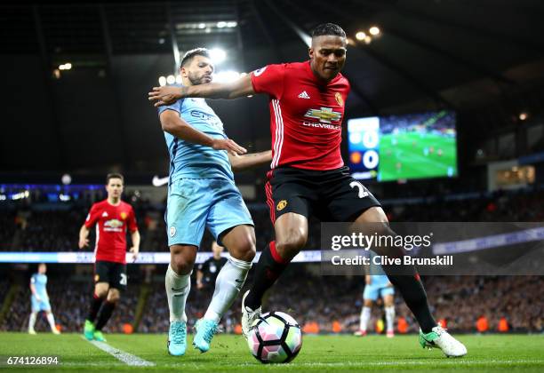 Antonio Valencia of Manchester United holds off Sergio Aguero of Manchester City during the Premier League match between Manchester City and...