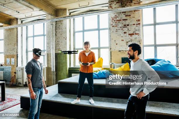 young start up business people flying a drone and testing ar software with vr googles - drone technology stock pictures, royalty-free photos & images