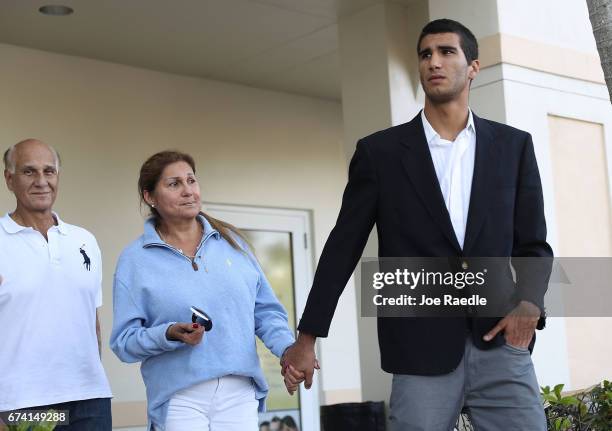 Marco Coello walks with his mother Dorys Morillo de Coello and father Armando Coello at the Blandon Law office after he was released from the...