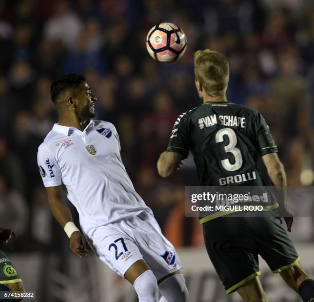 Uruguay's Nacional player Rodrigo Aguirre vies for the ball with Brazil's Chapecoense player Douglas Grolli during their Libertadores Cup football...