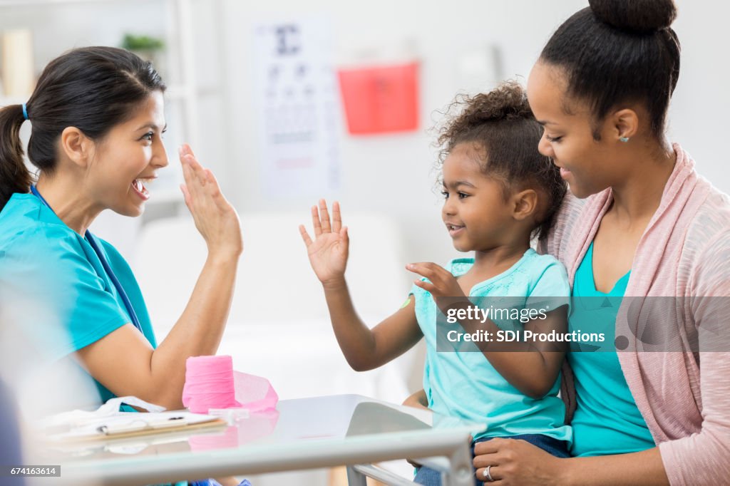 Young patient gives nurse high five