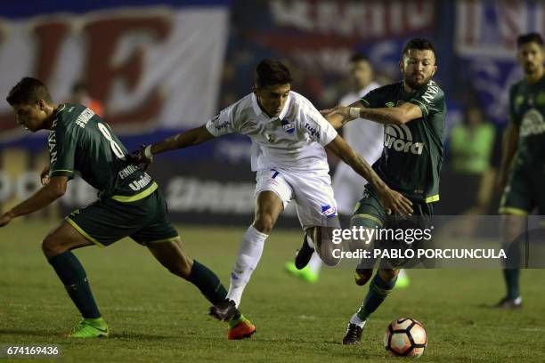 Uruguay's Nacional forward Kevin Ramirez vies for the ball with Brazil's Chapecoense midfielders Rossi and Andrei Girotto during their Libertadores...