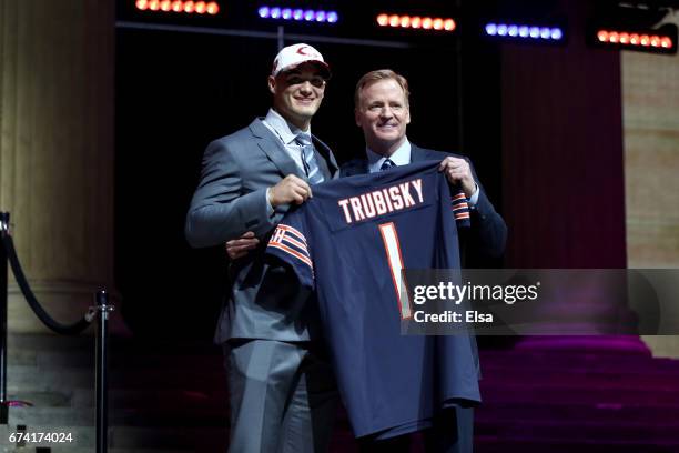 Mitchell Trubisky of North Carolina poses with Commissioner of the National Football League Roger Goodell after being picked overall by the Chicago...