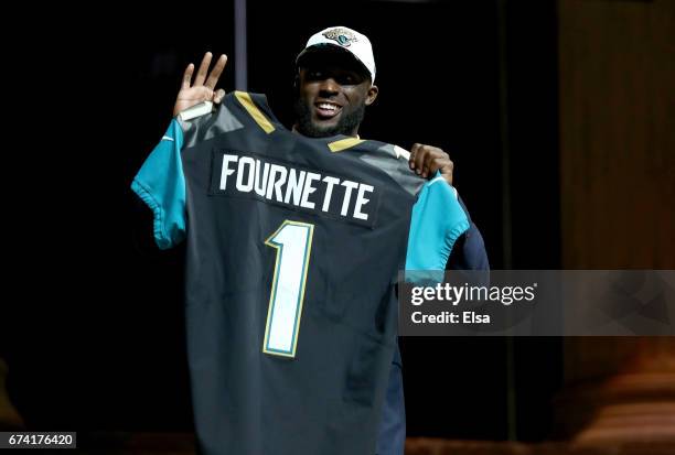 Leonard Fournette of LSU reacts poses after being picked overall by the Jacksonville Jaguars during the first round of the 2017 NFL Draft at the...