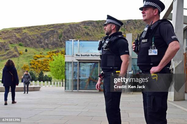 Police armed with Taser electroshock weapons patrol outside the Scottish Parliament, on April 27, 2017 in Edinburgh, Scotland. These and other new...