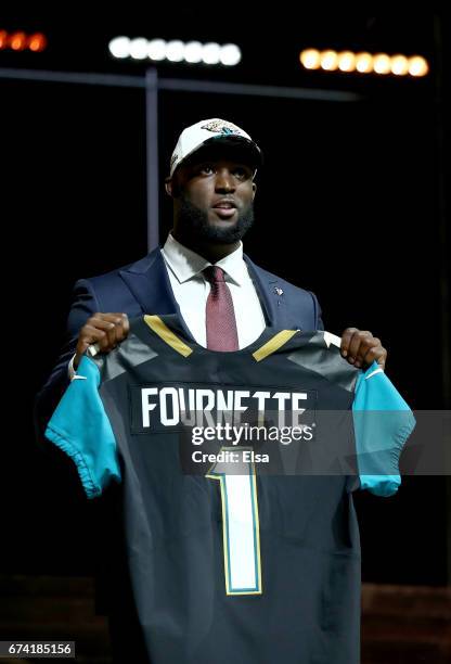 Leonard Fournette of LSU reacts poses after being picked overall by the Jacksonville Jaguars during the first round of the 2017 NFL Draft at the...