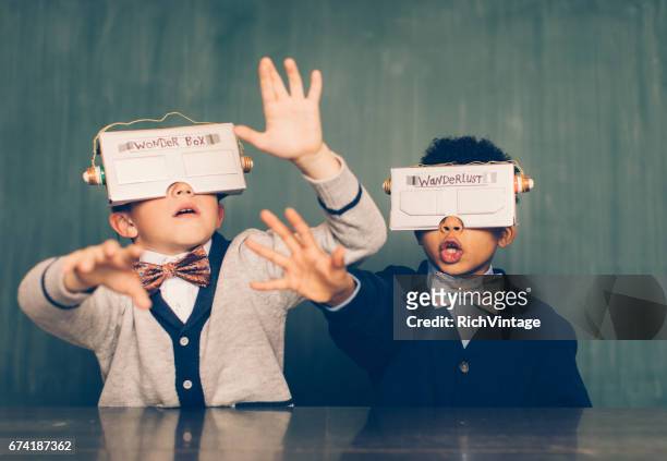 zwei junge männliche nerds mit virtual-reality-headsets - contact us stock-fotos und bilder