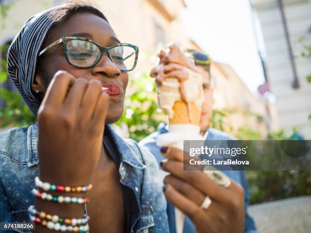 young mixed race couple with ice cream - enjoy stock pictures, royalty-free photos & images