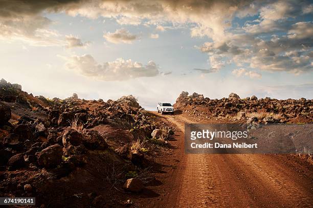 off road vehicle on a red dirt road. - chemin de terre photos et images de collection
