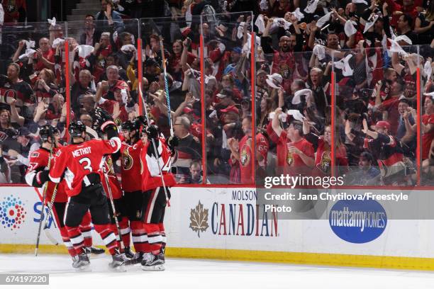 Erik Karlsson of the Ottawa Senators celebrates his third period game winning goal against the New York Rangers with teammates Tommy Wingels, Marc...
