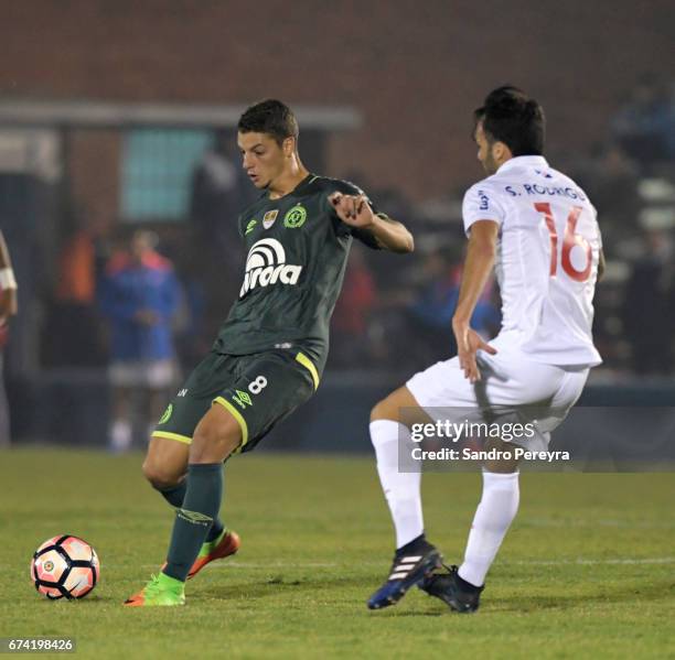 Andrei Girotto of Chapecoense defends the ball from Sebastian Rodriguez of Nacional fight for the ball during a match between Nacional and...