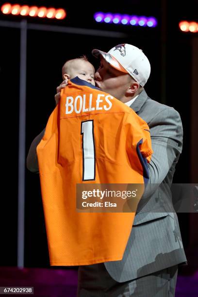 Garett Bolles of Utah kisses his son Kingston after being picked overall by the Denver Broncosduring the first round of the 2017 NFL Draft at the...