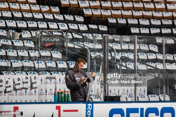 Frederik Andersen of the Toronto Maple Leafs prepares his stick before facing the Washington Capitals in Game Six of the Eastern Conference First...