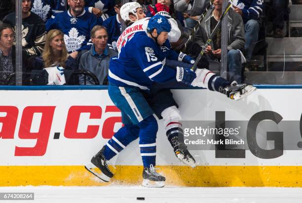 Matt Martin of the Toronto Maple Leafs checks Kevin Shattenkirk of the Washington Capitals during the second period in Game Six of the Eastern...