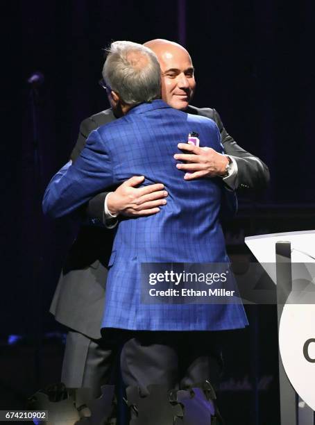 Former tennis player Andre Agassi accepts the Community Achievement Award from Keep Memory Alive Co-Founder Larry Ruvo during the 21st annual Keep...