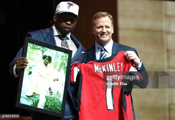 Takkarist McKinley of UCLA poses with Commissioner of the National Football League Roger Goodell after being picked overall by the Atlanta Falcons...