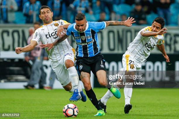 Luan of Gremio battles for the ball against Luis Cabral of Guarani during the match Gremio v Guarani as part of Copa Bridgestone Libertadores 2017,...