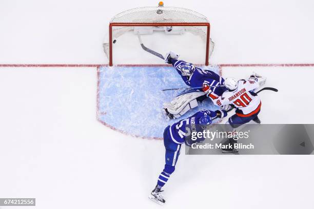 Marcus Johansson of the Washington Capitals scores the series winning goal against Martin Marincin and Frederik Andersen of the Toronto Maple Leafs...