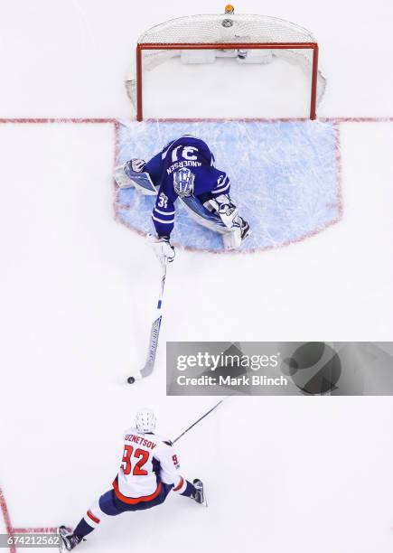 Evgeny Kuznetsov of the Washington Capitals is poke checked by Frederik Andersen of the Toronto Maple Leafs during the second period in Game Six of...