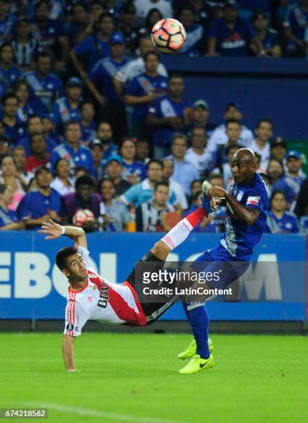 Gonzalo Martinez of River Plate takes a shot and Oscar Bagui of Emelec tries to block it during a group stage match between Emelec and River Plate as...