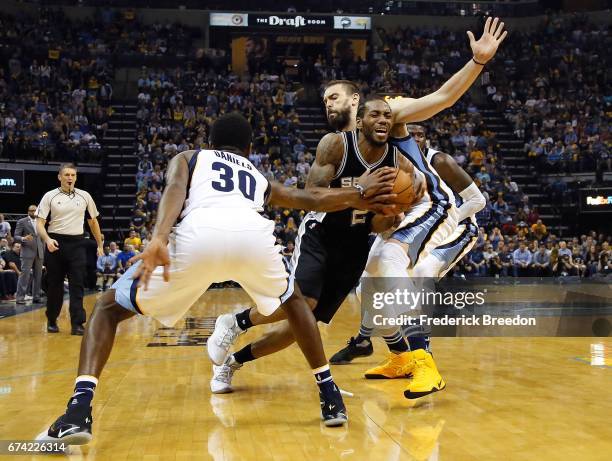 Kawhi Leonard of the San Antonio Spurs drives between Troy Daniels and Marc Gasol of the Memphis Grizzlies during the second half of a 103-96 Spurs...