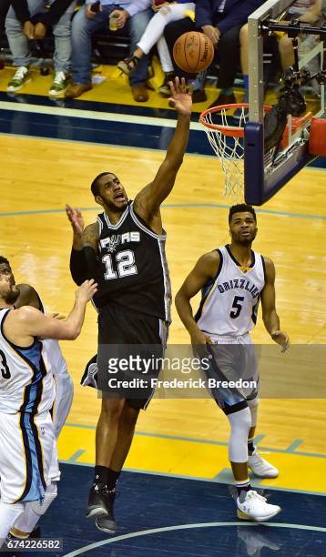Andrew Harrison of the Memphis Grizzlies watches LaMarcus Aldridge of the San Antonio Spurs take a shot during the second half of a 103-96 Spurs...