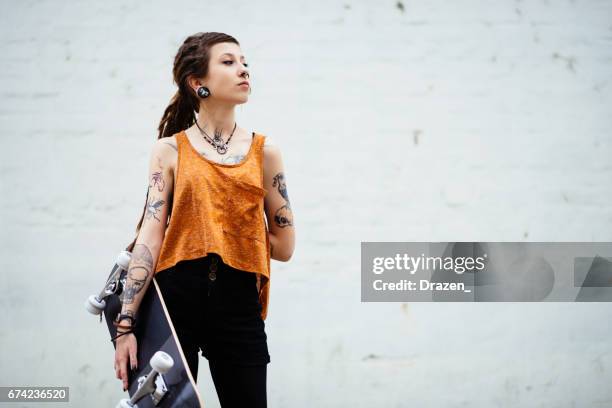 alternative lifestyle with tattoos and piercings - pierced stock pictures, royalty-free photos & images