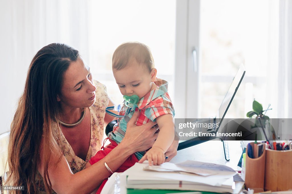 Mum with toddler working at her office