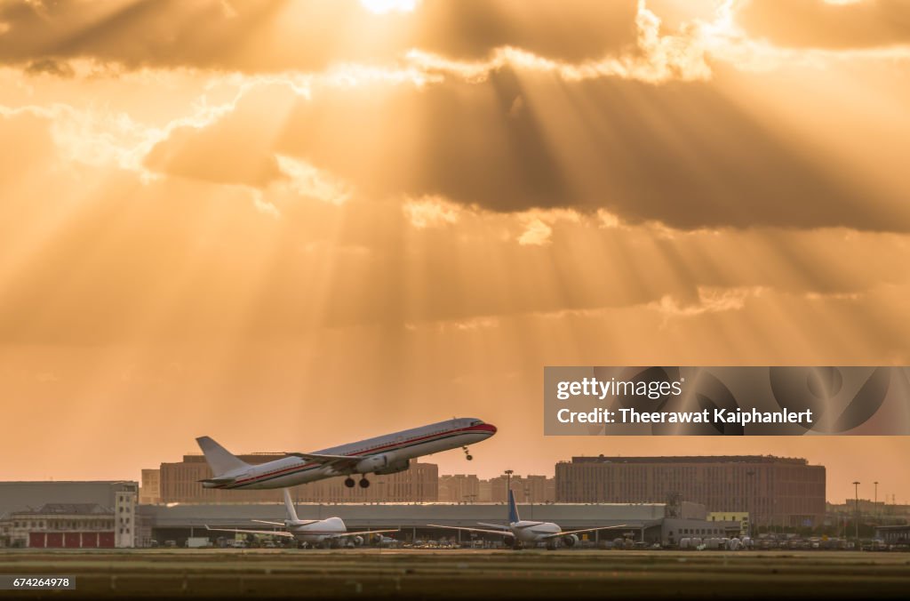 Passenger airplane flying during sunset