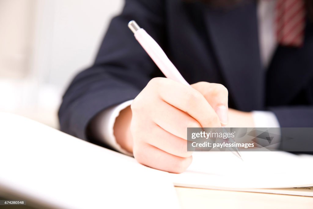 Of female junior high school student with a pencil at hand