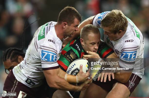 Jason Clark of the Rabbitohs is tackled during the round nine NRL match between the South Sydney Rabbitohs and the Manly Sea Eagles at Allianz...