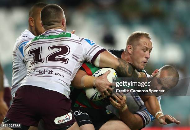 Jason Clark of the Rabbitohs is tackled during the round nine NRL match between the South Sydney Rabbitohs and the Manly Sea Eagles at Allianz...