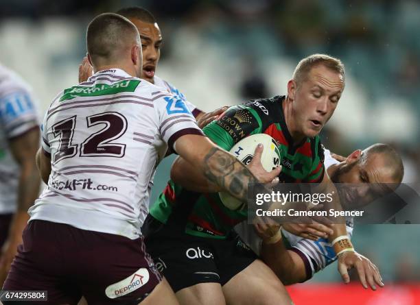 Jason Clark of the Rabbitohs is tackled during the round nine NRL match between the South Sydney Rabbitohs and the Manly Sea Eagles at Allianz...