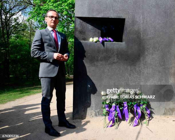 German Justice Minister Heiko Maas lays flowers on the memorial to the homosexuals persecuted by the Nazis after Germany cleared gays convicted under...