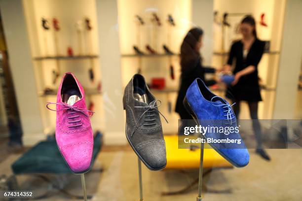 Colored suede shoes stand on display in the window of a retail store in the Burlington arcade in London, U.K., on Thursday, April 27, 2017. LVMH Moet...