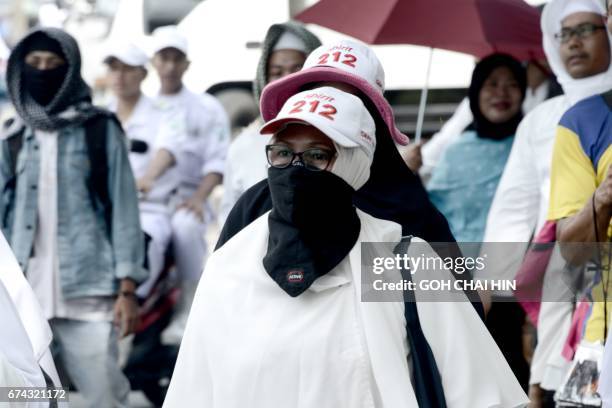 Muslim protesters take to the streets after Friday prayers in Jakarta on April 28 to protest against outgoing Jakarta governor Basuki Tjahaja...